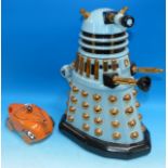 A large ceramic Dalek with detachable top; a 1930's style racing car ceramic teapot