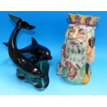 A 1930's Shorter "Father Neptune" character jug; a Poole group of 2 dolphins