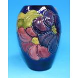 A Moorcroft floral decorated blue ground ovoid vase, 5½"