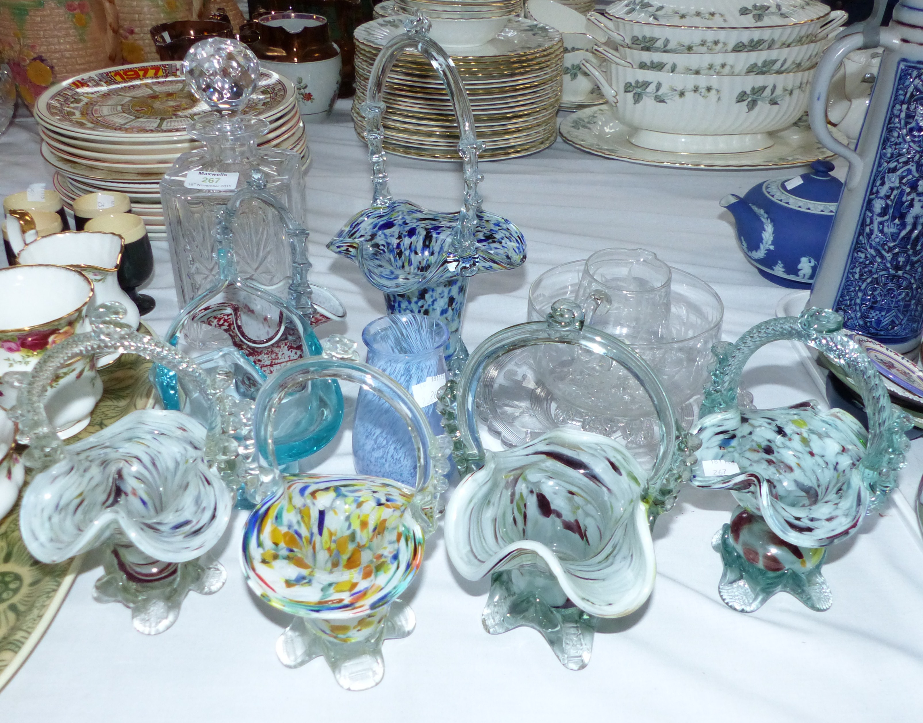 A collection of 7 Victorian and later spatter glass baskets and a cut crystal decanter and