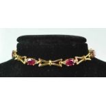 18ct Ruby Diamond Seti)  An 18ct yellow gold fancy link bracelet set with 6oval rubies and two 0.