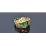 18ct Yellow Gold Emerald Diamond RingFeaturing an emerald cut emerald surrounded by baguette and