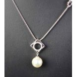 18ct White Gold Pearl Pendant A light cream 9.46mm cultured pearl suspendedfrom a double gallery