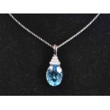 18ct White Gold Topaz Diamond PendantSwiss blue oval facetted Topaz approximately18.9x13.9mm = 13.