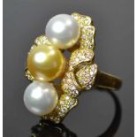 18ct South Sea Pearl and Diamond RingTwo white and one golden South Sea pearl set in a multi leaf