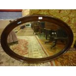 Oval bevelled mahogany framed wall mirror