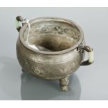 CHINESE PEWTER CENSER of circular bombe form and with jade effect insert lug handles, on three feet,