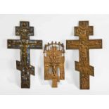 THREE 19TH-CENTURY RUSSION CRUCIFIXES one with blue enamel, largest 37.5cm long, smallest 26cm long