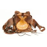 HAND TOOLED WESTERN SADDLE with floral motifs, stirrup leathers and stirrups intact, along with a