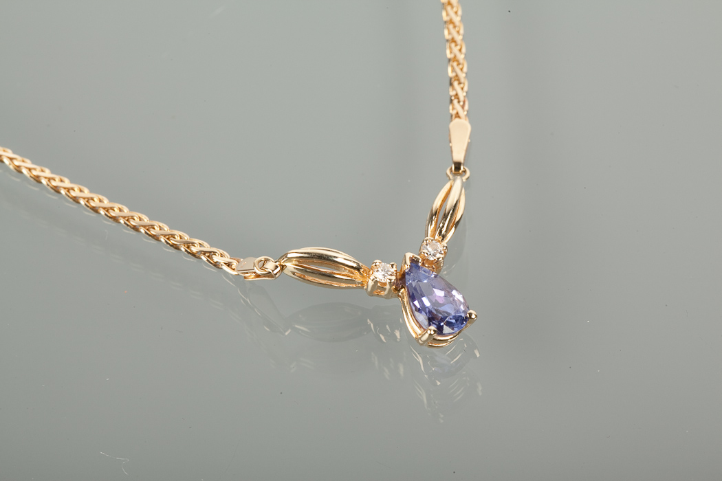 TANZANITE AND DIAMOND NECKLET set with a single pendeloque cut tanzanite approximately 8mm long with