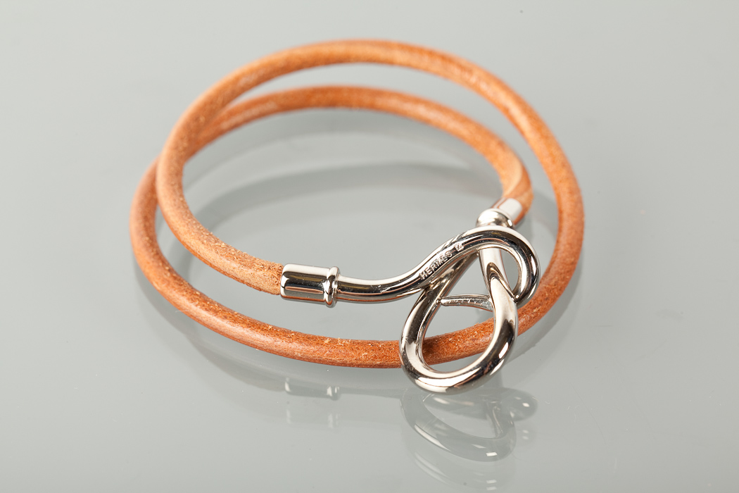 HERMES LEATHER BRACELET in tan leather, the buckle with HERMES and mongram, in box