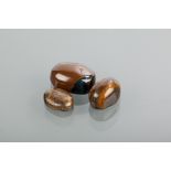 THREE UNMOUNTED TIGERS EYE STONES all of oval form