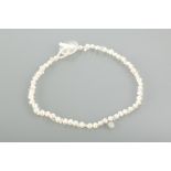 FRESHWATER PEARL NECKLACE formed by two rows of irregular white pearls, with a monogrammed drop