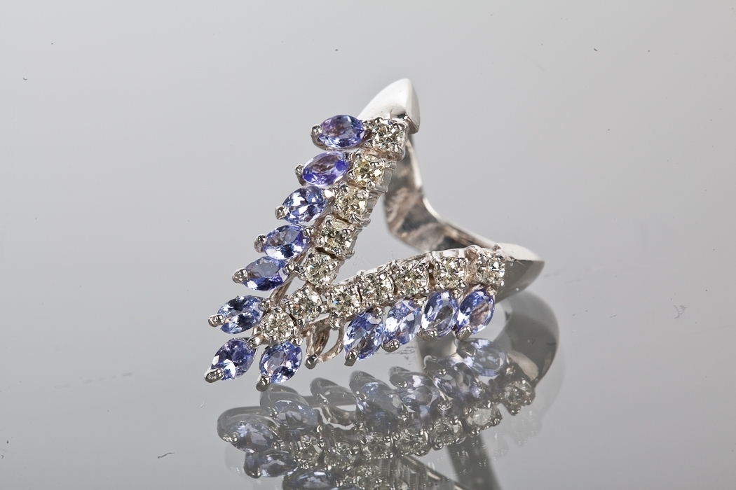 TANZANITE AND DIAMOND DRESS RING the open triangular ring set with oval tanzanites totalling