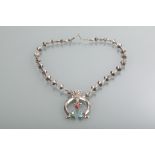 NORTH AMERICAN WHITE METAL TURQUOISE AND CORAL NECKLACE formed by an open circular drop set with
