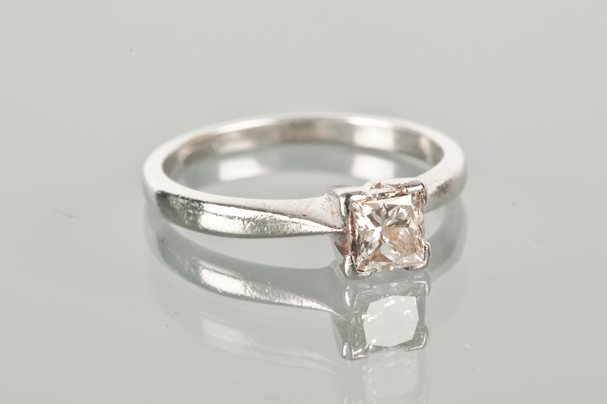 DIAMOND SOLITAIRE RING the princess cut diamond approximately 0.62 carats, in platinum, size L-M