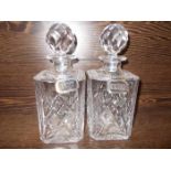 PAIR OF CUT GLASS DECANTERS WITH SILVER