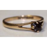 NINE CARAT GOLD GARNET SET RING