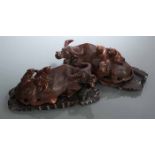 PAIR OF 19TH CENTURY CHINESE CARVED WOODEN WATER BUFFALO FIGURES
modelled as sitting buffalo with