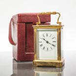 EARLY 20TH CENTURY BRASS CARRIAGE TIMEPIECE
with enamel Roman dial, inside a dark red leather case,