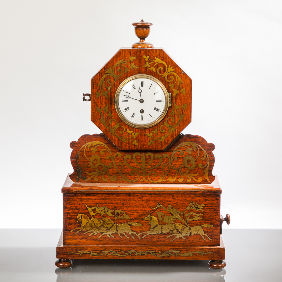 VICTORIAN BRASS INLAID ROSEWOOD MANTEL CLOCK
with an enamel Roman dial, the face of octagonal form,
