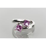 PINK TOURMALINE TWO STONE CROSSOVER RING set with two square cut tourmaline in an interlinking