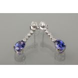 PAIR OF TANZANITE AND DIAMOND DROP EARRINGS 
each formed by an oval cut tanzanite drop of