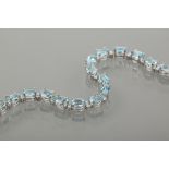 BLUE TOPAZ AND DIAMOND TENNIS BRACELET 
set with a total of 12.