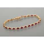 RUBY AND DIAMOND BRACELET 
set with twenty four square cut rubies interspersed with baguette cut