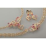 SUITE OF EIGHTEEN CARAT GOLD RUBY AND DIAMOND SET JEWELLERY
the necklet with decorative central