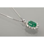 EMERALD AND DIAMOND CLUSTER PENDANT 
set with a central oval cut emerald of approximately 1.