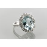 IMPRESSIVE AQUAMARINE AND DIAMOND CLUSTER RING 
set with a central oval aquamarine of 4.