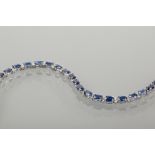 FINE SAPPHIRE AND DIAMOND TENNIS BRACELET 
set with a total of 8.