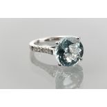 IMPRESSIVE EIGHTEEN CARAT AQUAMARINE AND DIAMOND RING 
set with a single brilliant cut aquamarine