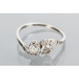 MID TWENTIETH CENTURY DIAMOND TWO STONE RING
the two diamonds in a crossover setting and totalling