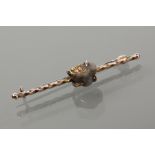EARLY TWENTIETH CENTURY GOLD NUGGET BAR BROOCH
of twist design, set with a gold nugget in host rock,