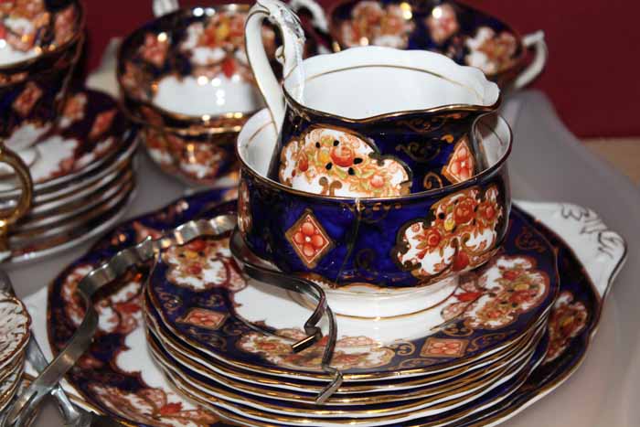 ROYAL ALBERT TEA SET
in blue, and brown floral pattern with gilt detail, six cups, saucers,