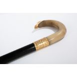 EDWARDIAN GOLD PLATED MOUNTED HORN HANDLED WALKING STICK
the ebonised stick terminating in brass