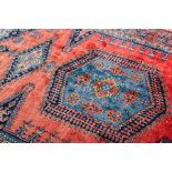 INDO-PERSIAN DESIGN RUG
the red field and with blue patterned border, approximately 349cm long,