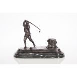 CAST METAL INKWELL MODELLED AS A GOLFER
stamped "WELLINGTON 1822", on a marble-effect base,