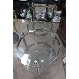 TWO CIRCULAR GLASS TOPPED TABLES
and another