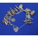 GOOD SILVER CHARM BRACELET
with charms including a caroussel, a post box, a horse etc.