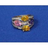 EIGHTEEN CARAT GOLD AND CUBIC ZIRCONIA SET DRESS RING
with amber, purple and pink stones,