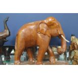 THREE CARVED WOODEN ELEPHANT FIGURES
of various size,