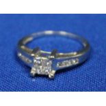 DIAMOND CLUSTER RING
the square shaped bezel set with four square cut diamonds,