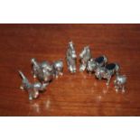EIGHT SILVER MINIATURE DOG FIGURES
including two pin cushion bulldogs, a poodle key ring etc.