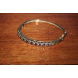 VICTORIAN GOLD SPINEL SET BANGLE
with detailed scroll work to setting