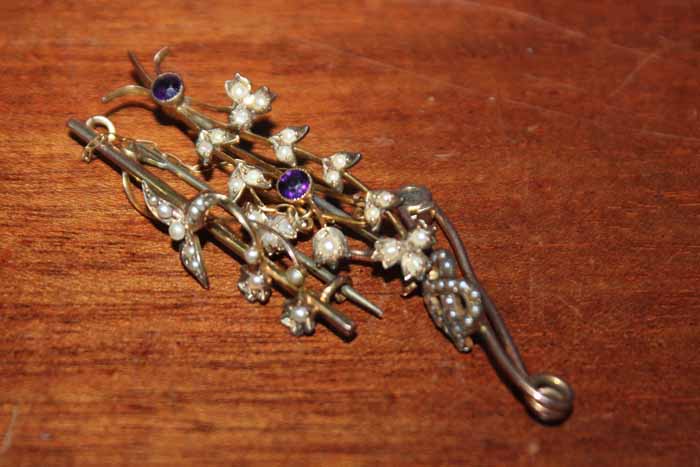 THREE EALRY 20TH CENTURY GOLD BAR BROOCHES
including a foliate design set with amethyst and seed