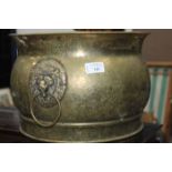 CIRCULAR BRASS PLANTER
with lion mask ring handles;