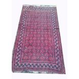 AN ANTIQUE PERSIAN BEALUCHI RUG,   With